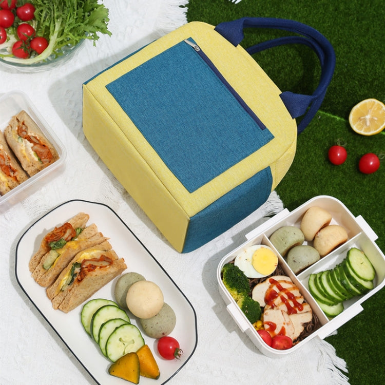 Yellow and dark blue insulated lunch tote handbag with food inside and front zip pocket