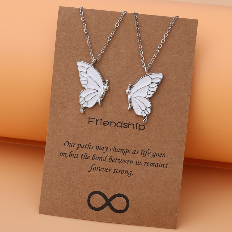 Gold butterfly pendant necklace set with two white enamel butterfly charms on chain