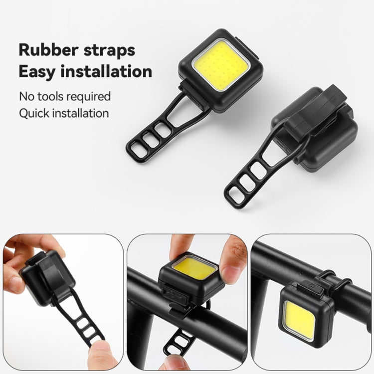 Mini LED bike lights with black housing and rubber strap mounts, yellow front LED