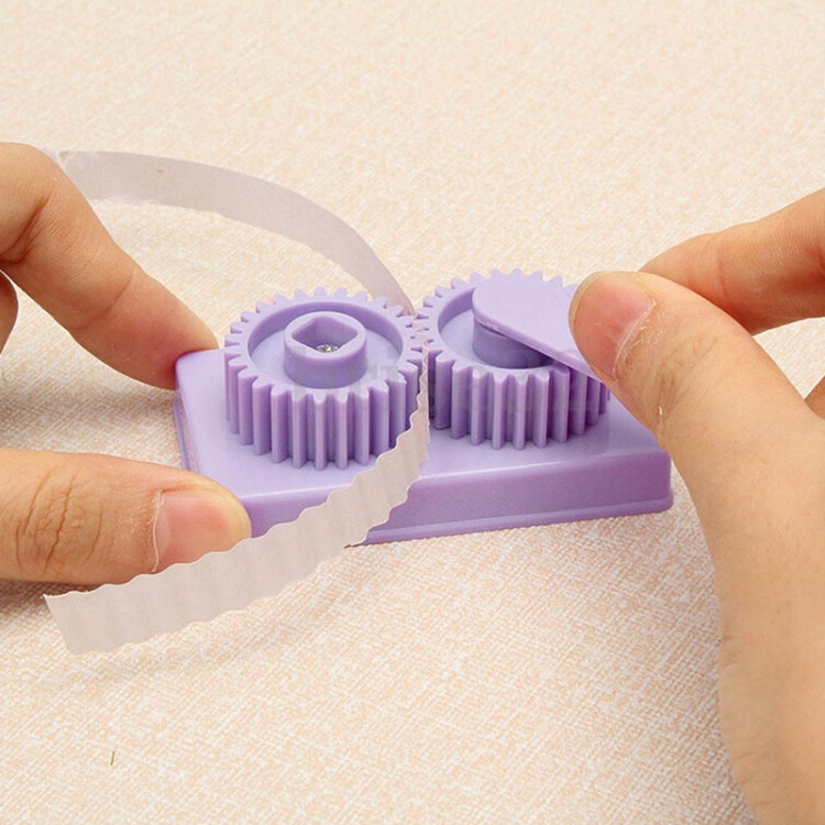 Hands using lavender quilling crimper tool to press paper into spiral shapes