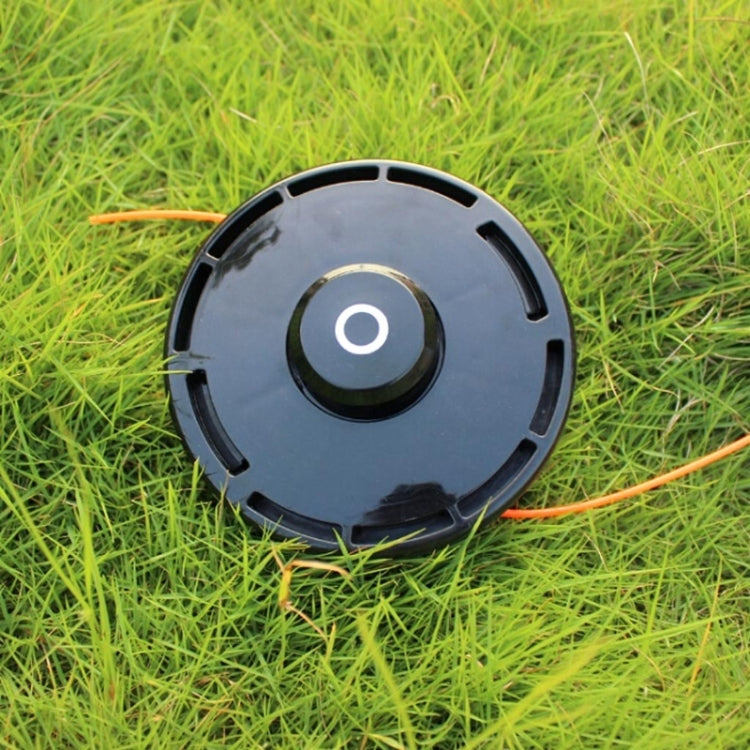 Grass trimmer cutting head with orange nylon line extending from spool