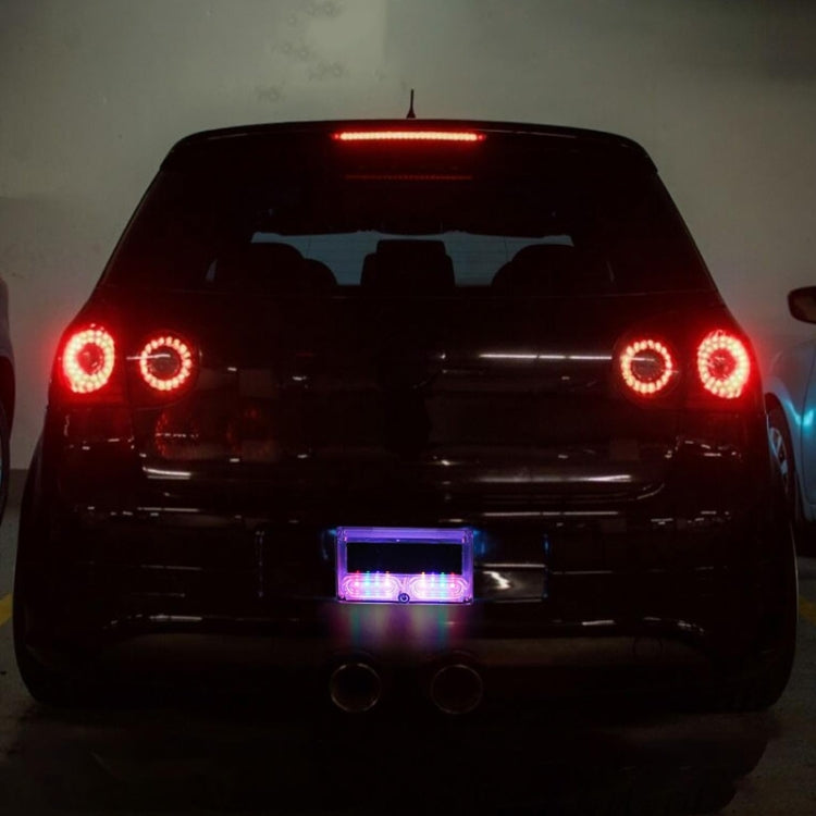 Rear view of car with glowing purple solar LED warning light in the license area