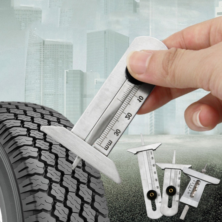 Hand using stainless steel tire tread depth gauge on tire tread, mm markings visible