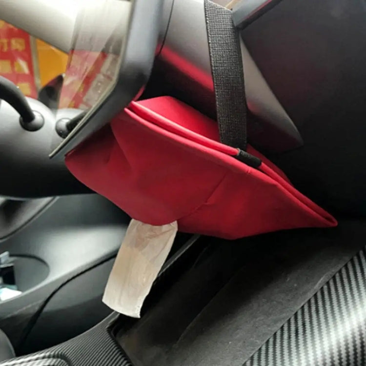 Red tissue storage pouch installed on car seat armrest with tissue pulled out