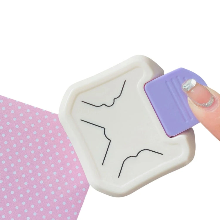 3-in-1 corner punch tool pressing a corner cut into patterned paper