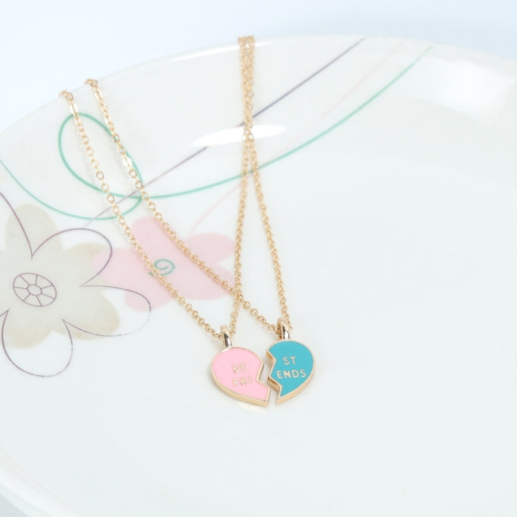 Gold-tone heart pendant necklace with pink and blue lock halves on layered chains