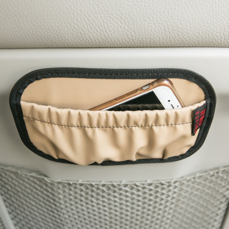 Beige hanging storage pocket on car console, holding a smartphone.