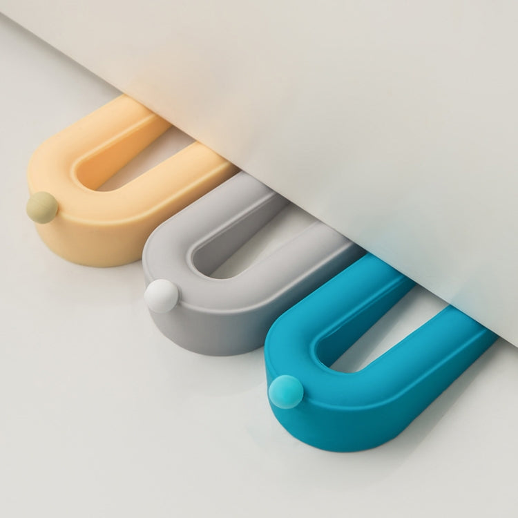 Set of blue, gray, and cream donut door stoppers with oval slots and pegs