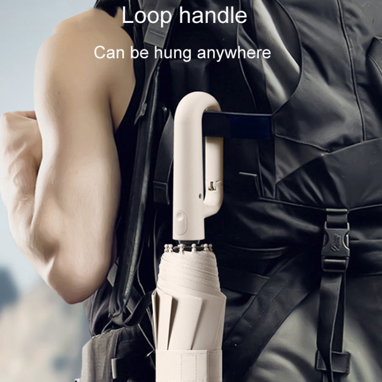 Folded umbrella with loop handle and carrying strap.