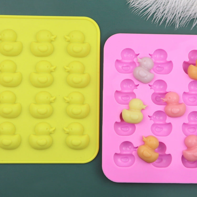 Silicone duck moulds in yellow and pink with duck-shaped cavities and figures
