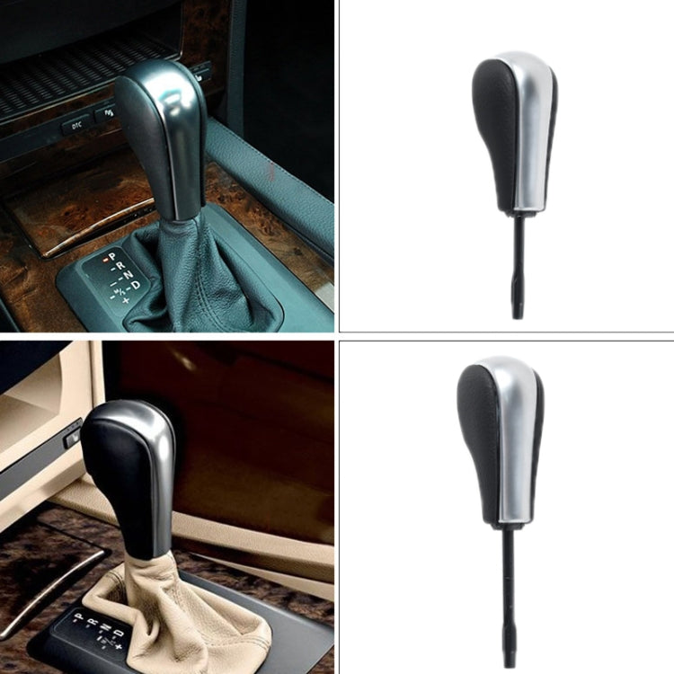 Round gear lever knob with black leather top, silver collar, and long stem
