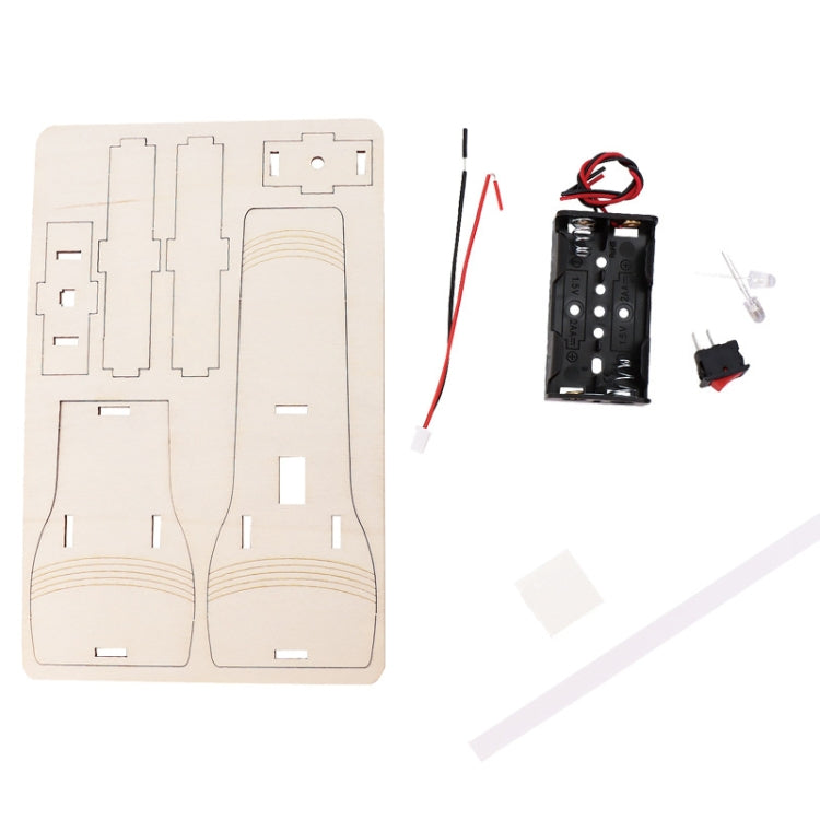 Flashlight kit parts layout: wooden template board and black battery module.