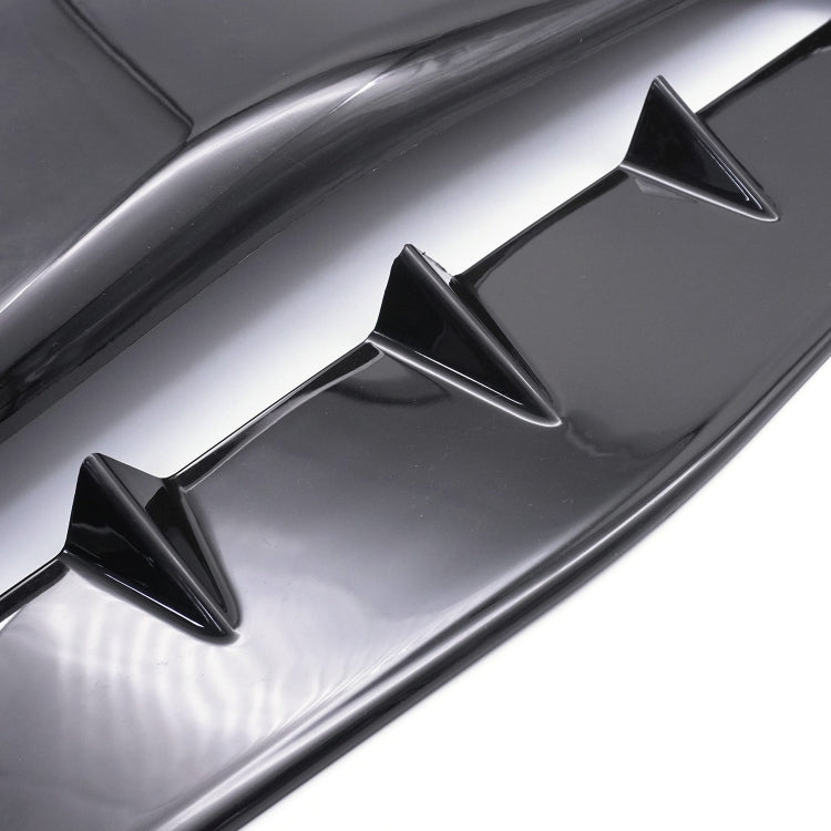Close-up of glossy black hood vent scoop cover with three raised intake fins