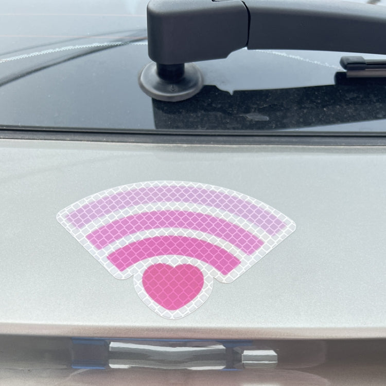 Reflective car warning sticker with pink heart and arc signal lines on car hood