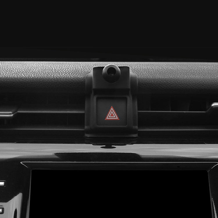 Black phone holder base mounted on car air vent, centered button release