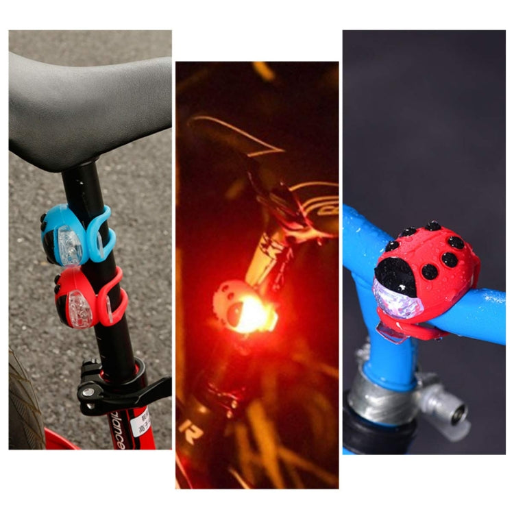 Red ladybug LED bicycle headlight with white beam, silicone clamp for handlebar