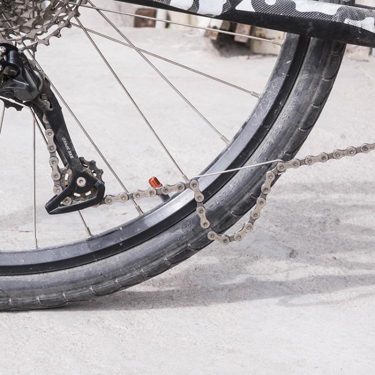 Bicycle chain repair hook tool clipped to chain near rear wheel