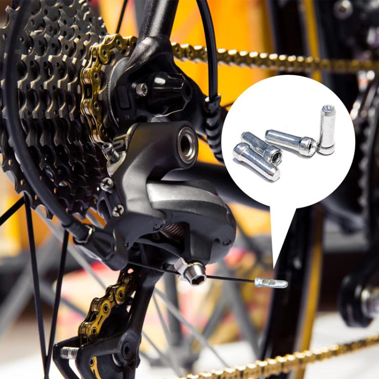 Aluminum bicycle cable tail caps on a bike cable, silver metal with inset pair