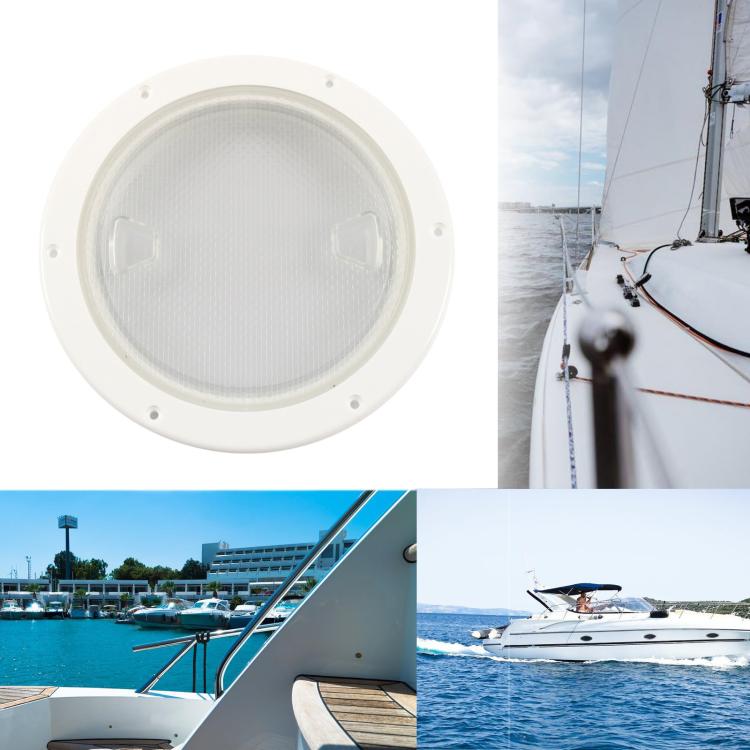 Round marine deck cover with clear lens shown installed on a sailboat