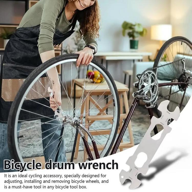 Bicycle hub wrench tool near wheel spokes, multi-size open key