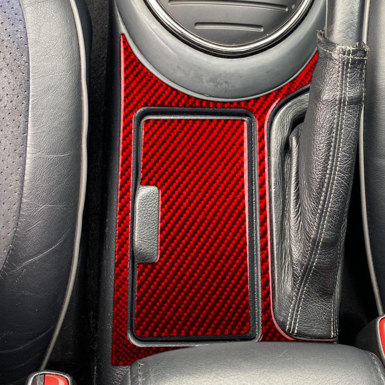 Red carbon-fiber cupholder sticker set installed beside gear selector, left-hand drive