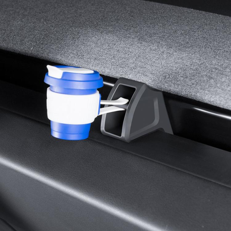 Car air vent clip mount bracket installed with a blue-and-white aromatherapy bottle
