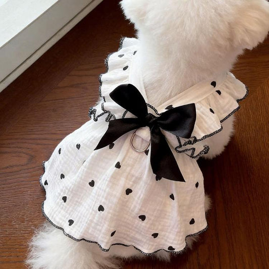 Cat harness dress in white with black bow at chest, heart dot pattern, ruffle hem