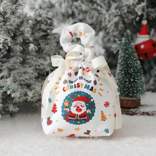 White fabric Christmas drawstring pouch with Santa print and ribbon ties.