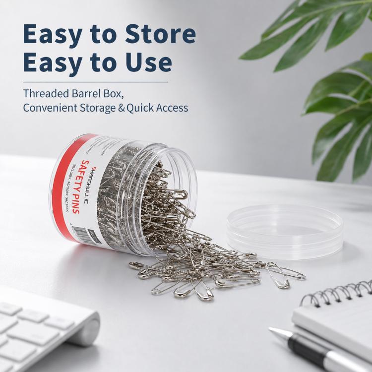 Stainless safety pins in clear threaded barrel box, pins spilled for easy access