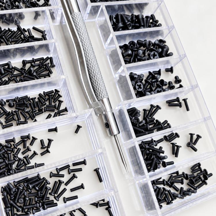 Close-up of clear multi-compartment organizer with black micro Phillips screws