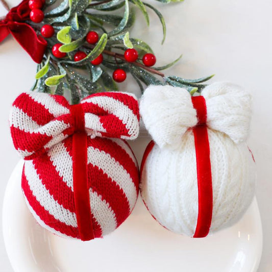 Pair of striped red-and-white and white knitted bow ornaments with red cords