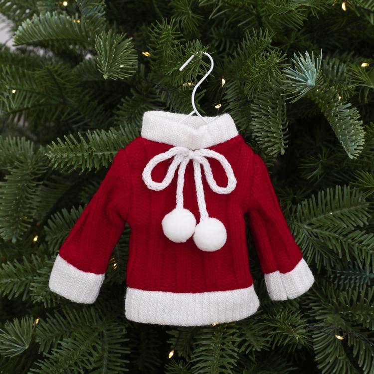Mini knitted red sweater ornament with white bow and three pom pom accents.