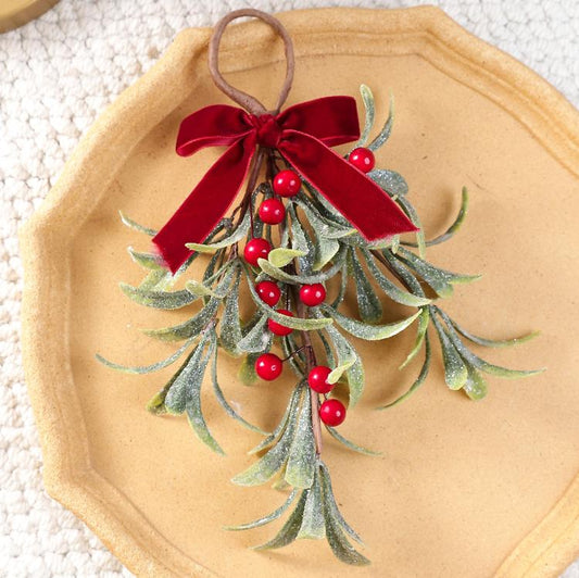 Artificial mistletoe hanging ornament with red velvet bow, red berries, frosted greenery