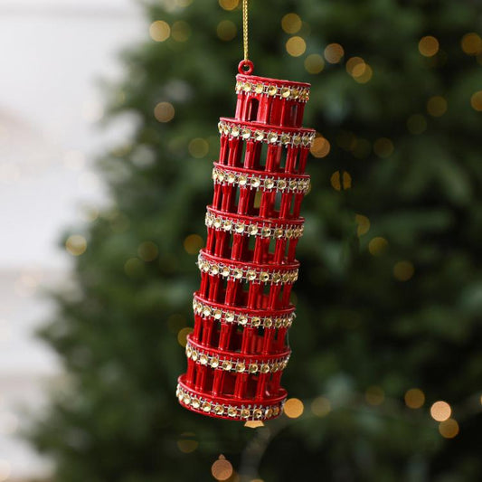 Diamond-studded leaning tower ornament in red with hanging loop and metallic accents