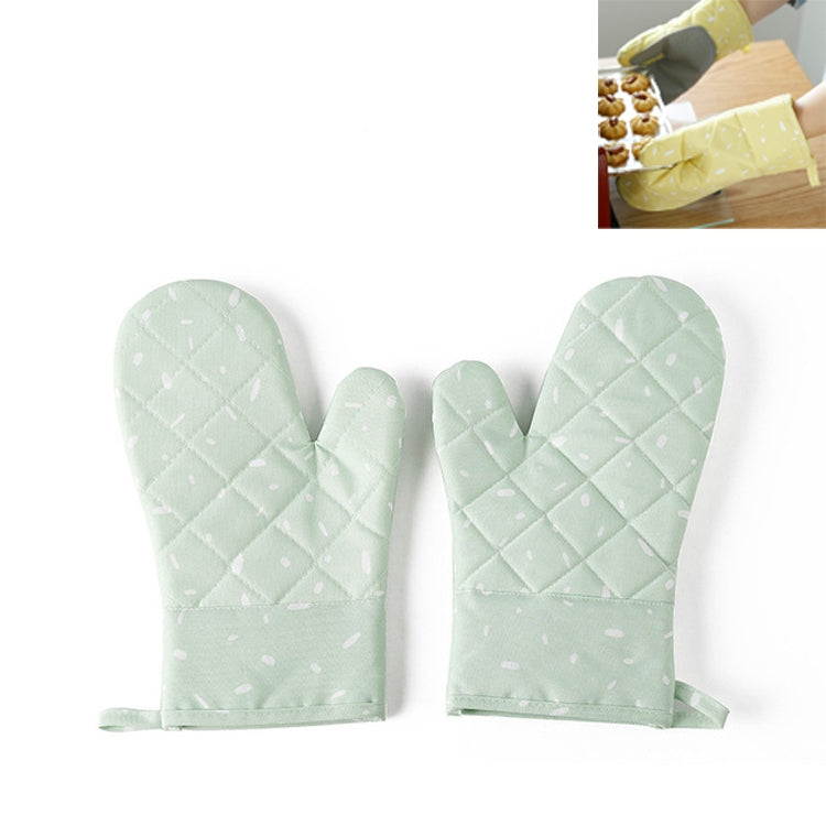 Light green quilted heat-resistant oven mitt pair with dotted pattern and textured palm