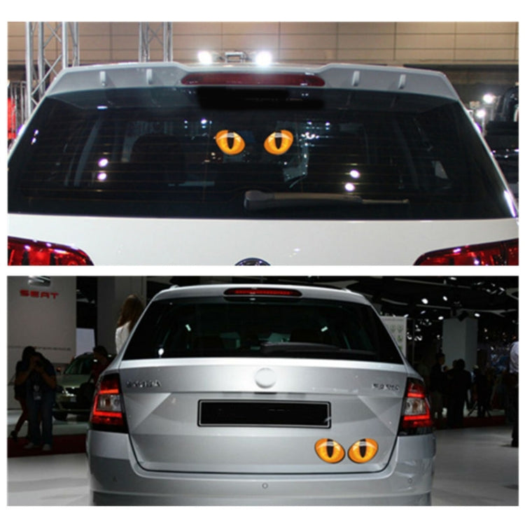 Orange cat-eye vinyl decals on a car rear window and trunk