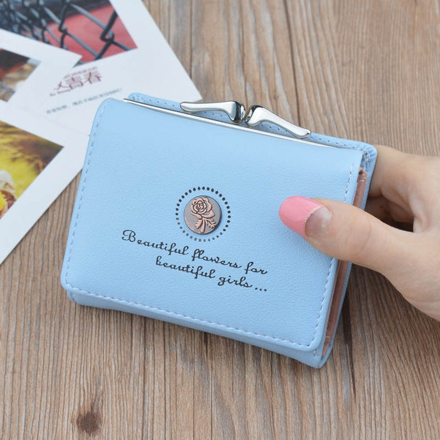 Blue mini folding wallet coin purse with floral emblem and metal clasp, stitched border