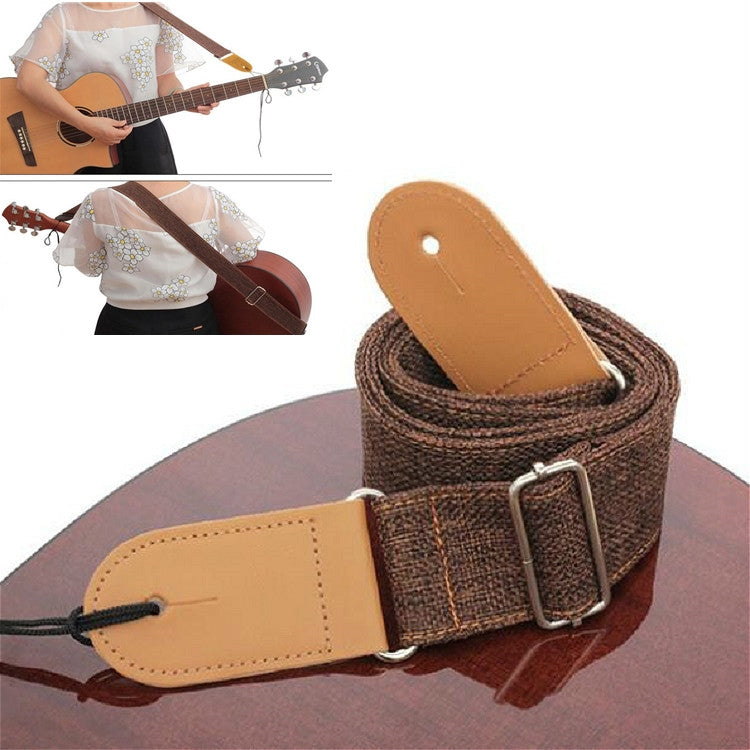 Dark brown woven guitar strap with tan end tab, metal buckle, and adjustable loop