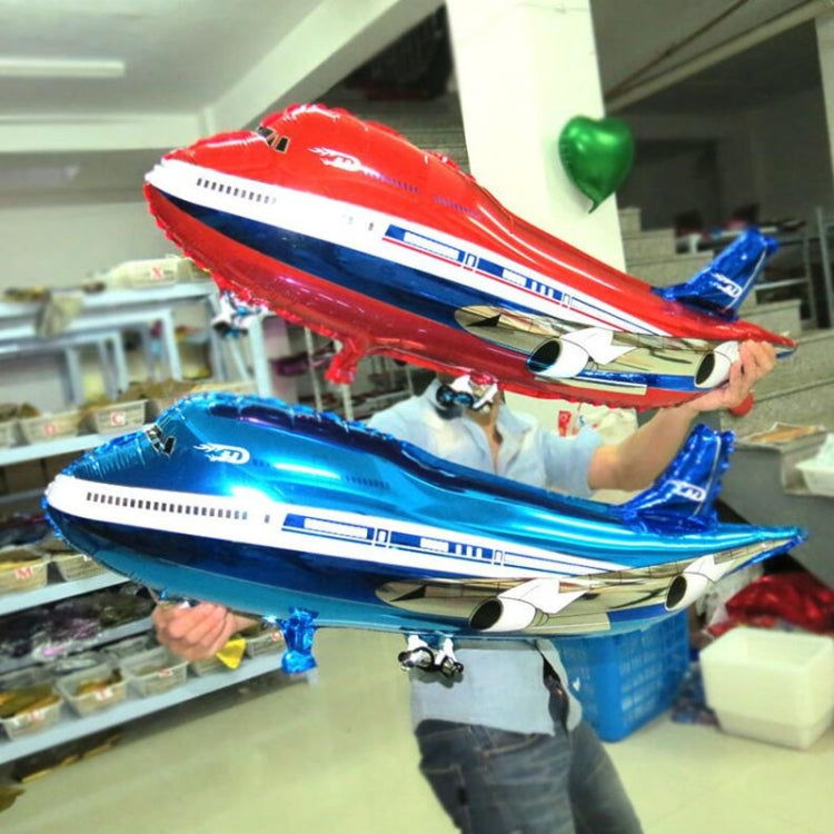 Airplane balloon toy set held by hands: red top, blue bottom with engine details