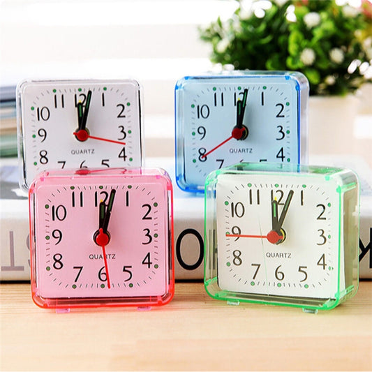 Assorted square quartz alarm clocks with transparent cases in pink, blue, and green
