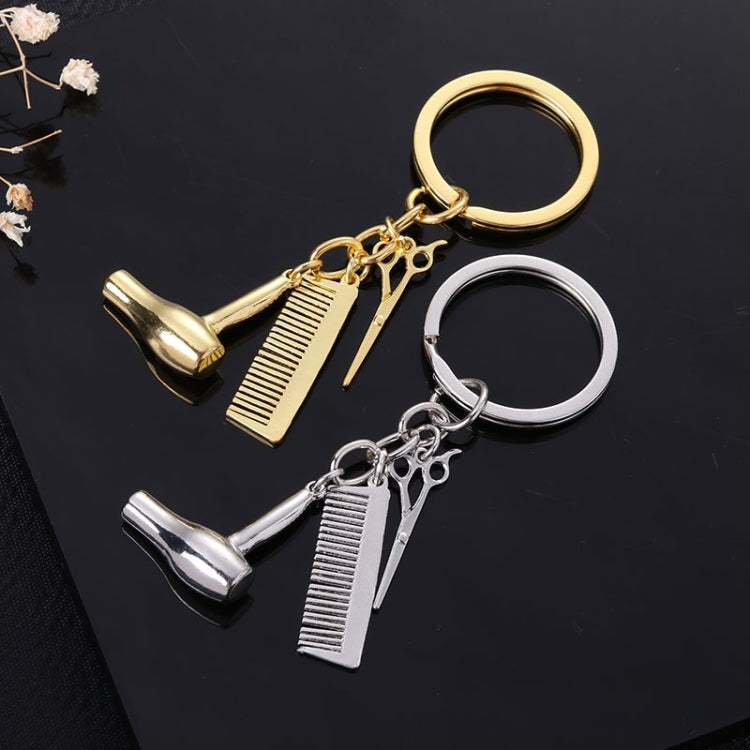 Comb-shaped key rings in silver and gold with scissors and shoe charms
