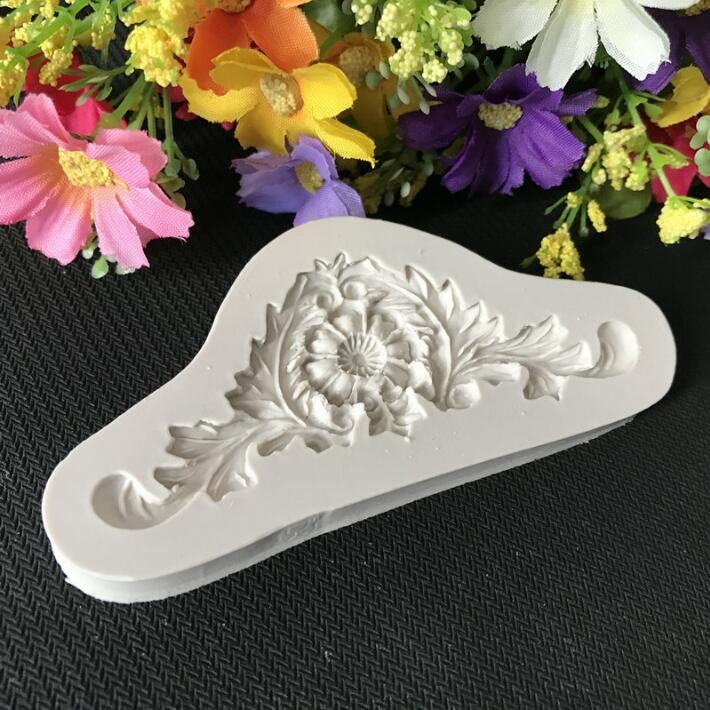White silicone fondant mold with embossed flower vine lace pattern and floral center