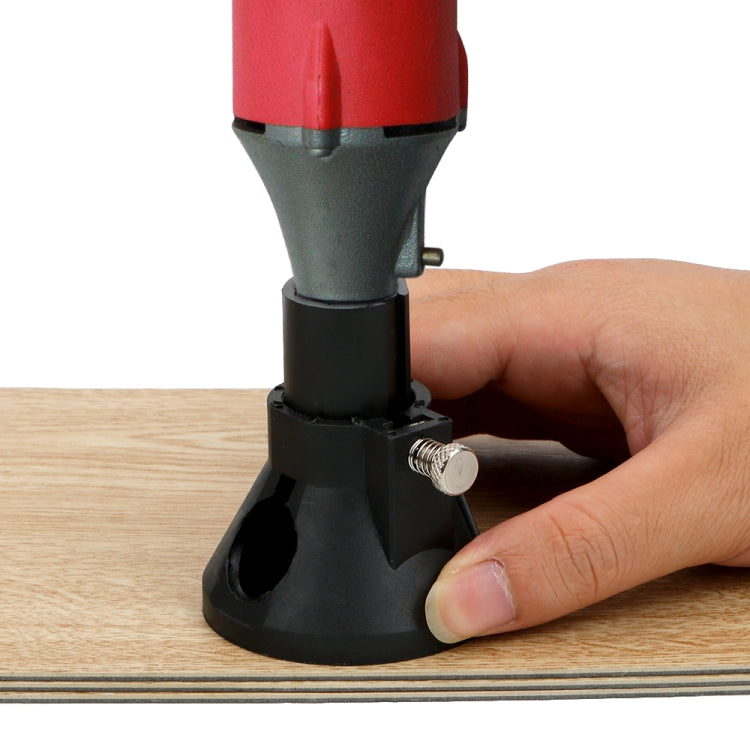 Hand using black locator milling cutter on a wooden board with router tool