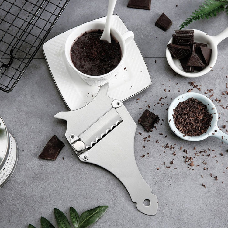 Stainless steel fork slicer with chocolate pieces and grated chocolate on kitchen counter