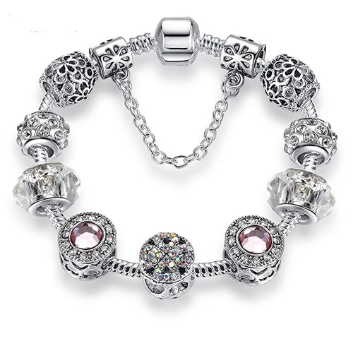 Silver-tone charm bracelet with pink round crystals, clear faceted beads, and decorative bead charms