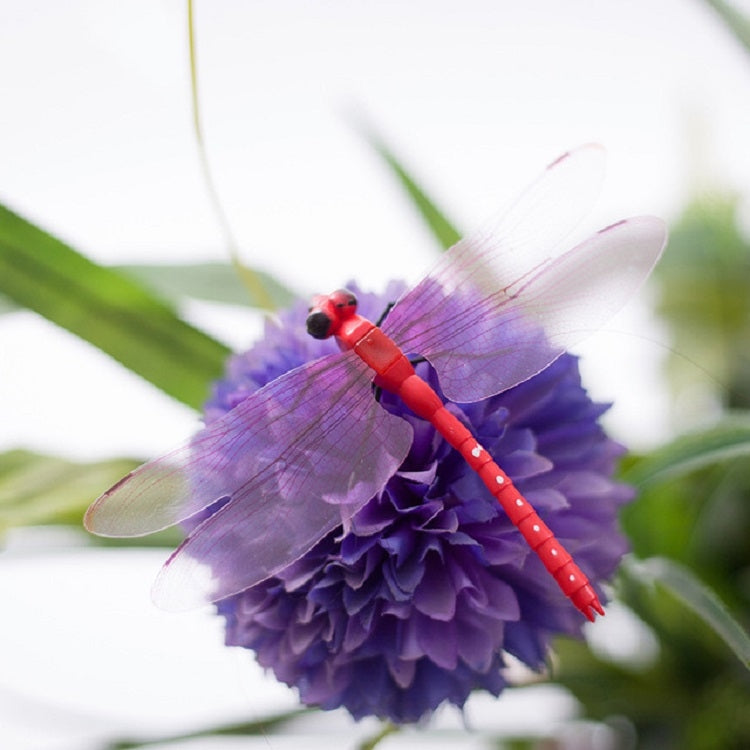 Purple dragonfly decoration with translucent wings and stick handle