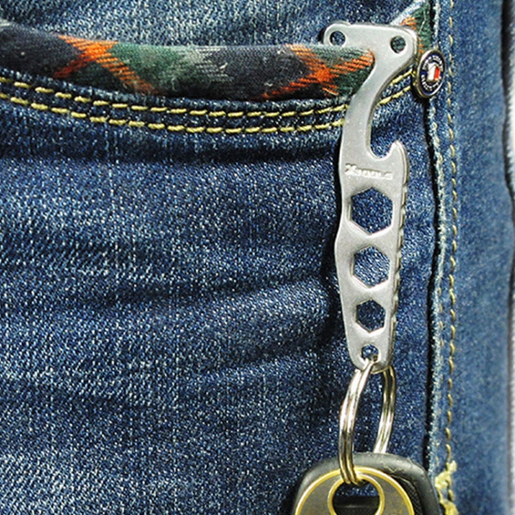 Stainless steel bottle opener key holder clipped to blue denim pocket