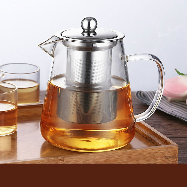 Glass teapot with stainless steel lid and handle; amber tea and metal filter visible