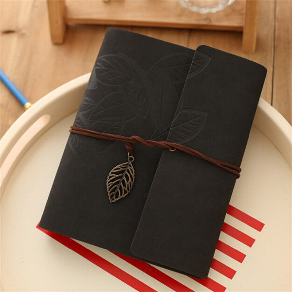 Black PU leather vintage photo album with embossed leaf pattern, twine tie, and leaf charm.