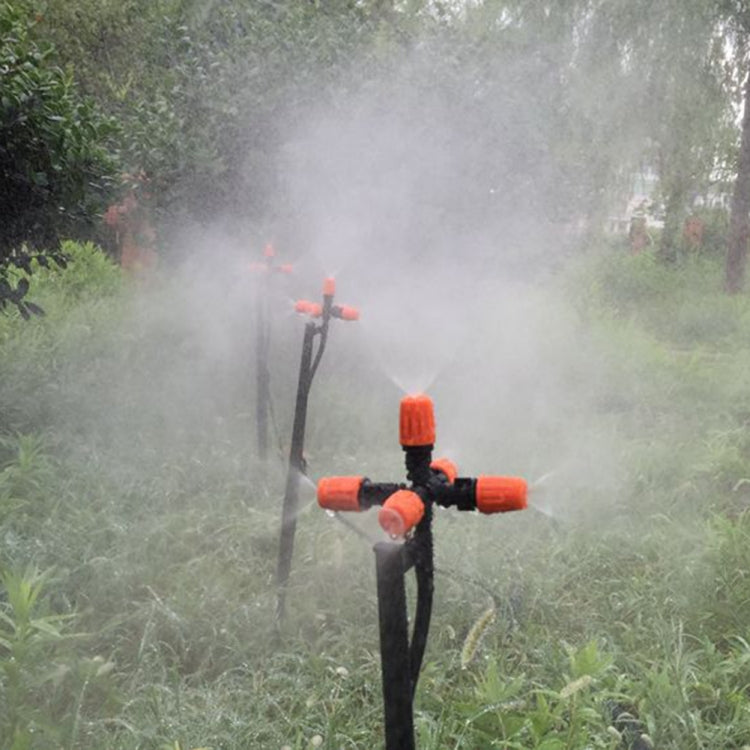 Cross-five outlet spray nozzle mounted on tripod stand, orange tips spraying mist